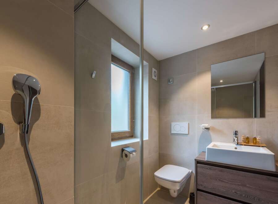 This modern bathroom features a sleek design with neutral tones and a minimalist aesthetic.