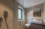This modern bathroom features a sleek design with neutral tones and a minimalist aesthetic.