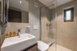 This modern bathroom features a sleek, minimalist design with a spacious walk-in shower.