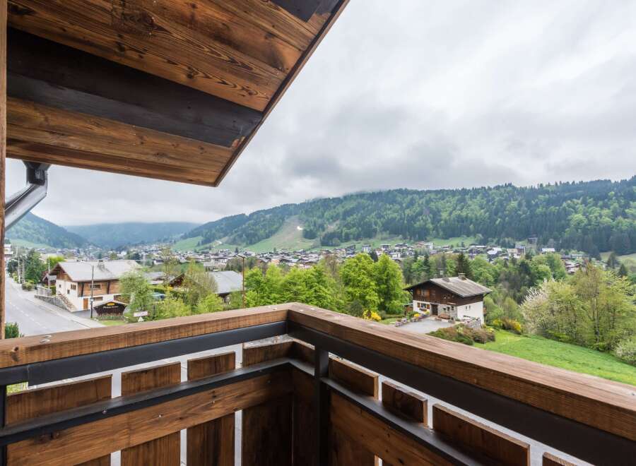 Enjoy breathtaking mountain views from this charming balcony.