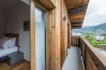 Experience the charm of this stunning property with its rustic wooden facade and inviting balcony.