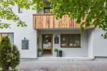 Discover a charming property with a wooden balcony and inviting entrance.