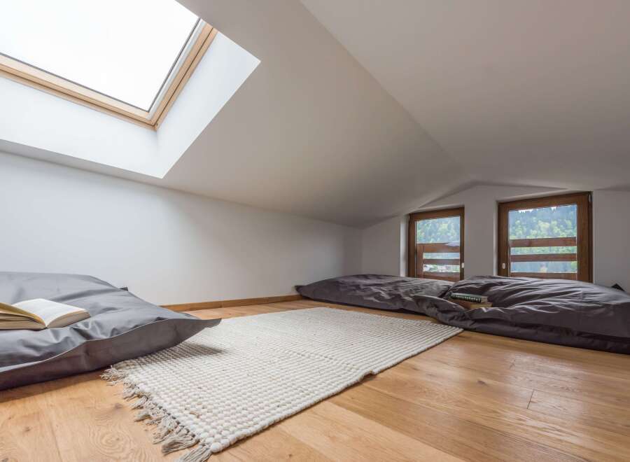 Discover a cozy attic retreat with a unique design.