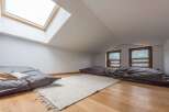 Discover a cozy attic retreat with a unique design.