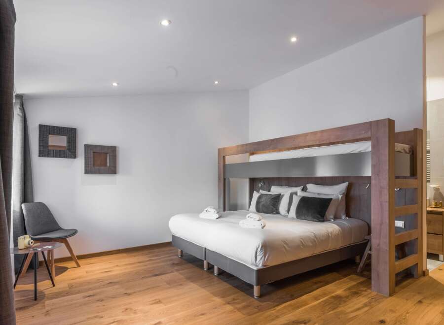 This modern bedroom features a stylish bunk bed, perfect for families or groups.