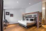 This modern bedroom features a stylish bunk bed, perfect for families or groups.