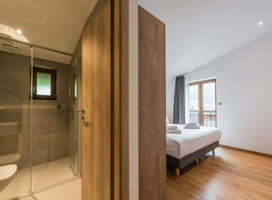 Discover a luxurious retreat in this stunning property, featuring a modern bathroom with a sleek glass shower.