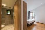 Discover a luxurious retreat in this stunning property, featuring a modern bathroom with a sleek glass shower.