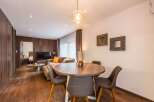 This stunning property boasts a modern living space with a cozy seating area and a dining table perfect for entertaining.