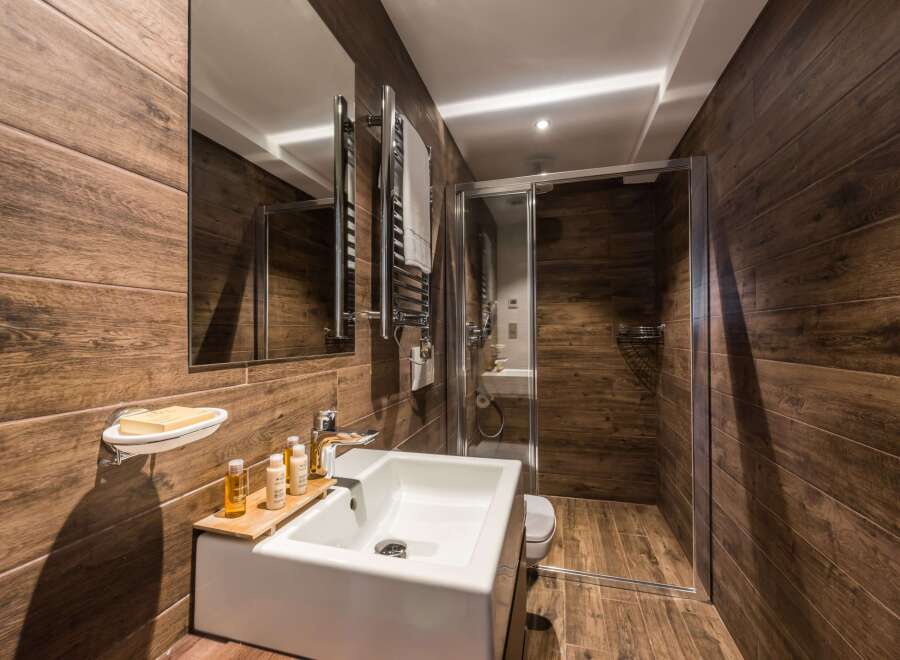 Step into a luxurious bathroom with stunning wood-look tile, creating a warm and inviting atmosphere.