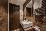 This modern bathroom features a sleek, minimalist design with a wooden accent wall.