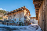 Discover the charm of this stunning wooden chalet, nestled in a picturesque winter landscape.