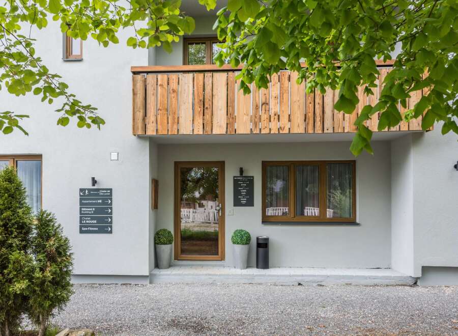 Discover a charming property with a wooden balcony and inviting entrance.