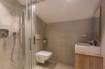 This modern bathroom features a sleek shower enclosure and a minimalist design.