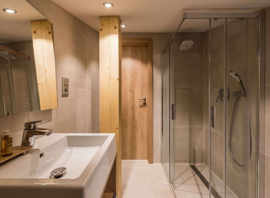 This modern bathroom features a sleek glass shower and a stylish sink area.