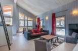 This stunning chalet boasts a spacious open-plan living area with floor-to-ceiling windows offering breathtaking views.