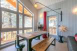 This stunning chalet boasts a spacious dining area with a rustic wooden table and benches, perfect for enjoying meals with breathtaking views.