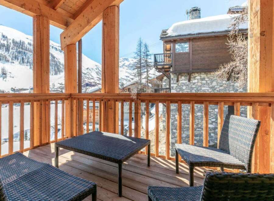 This stunning chalet boasts a spacious balcony with breathtaking mountain views, perfect for enjoying the crisp alpine air.