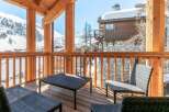 This stunning chalet boasts a spacious balcony with breathtaking mountain views, perfect for enjoying the crisp alpine air.