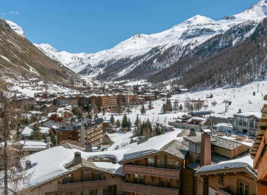 Luxury chalet in the heart of the French Alps, offering breathtaking views of snow-capped mountains and the charming village below.