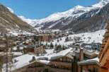 Luxury chalet in the heart of the French Alps, offering breathtaking views of snow-capped mountains and the charming village below.