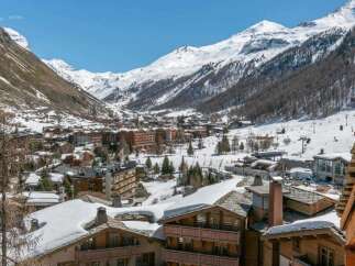 Luxury chalet in the heart of the French Alps, offering breathtaking views of snow-capped mountains and the charming village below.