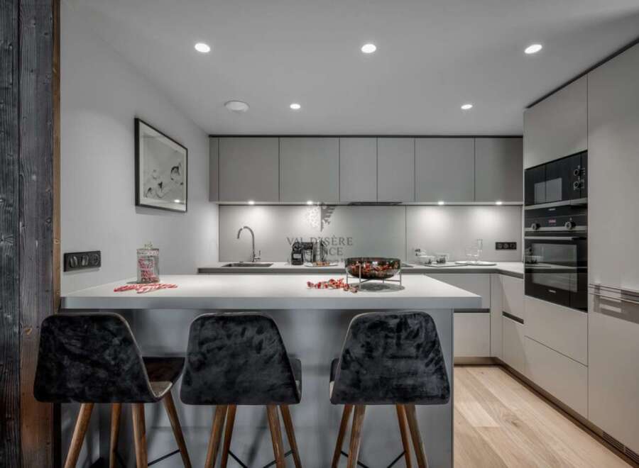 Modern kitchen with sleek gray cabinets and integrated appliances.