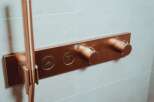 Luxury bathroom featuring a sleek, copper-finished shower system with integrated controls.