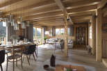 Experience the charm of this stunning wooden cabin, featuring a spacious living area with a cozy fireplace.