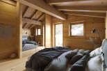 Experience the warmth of this stunning wooden bedroom, a perfect retreat for relaxation.