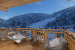 Enjoy breathtaking mountain views from this cozy balcony.
