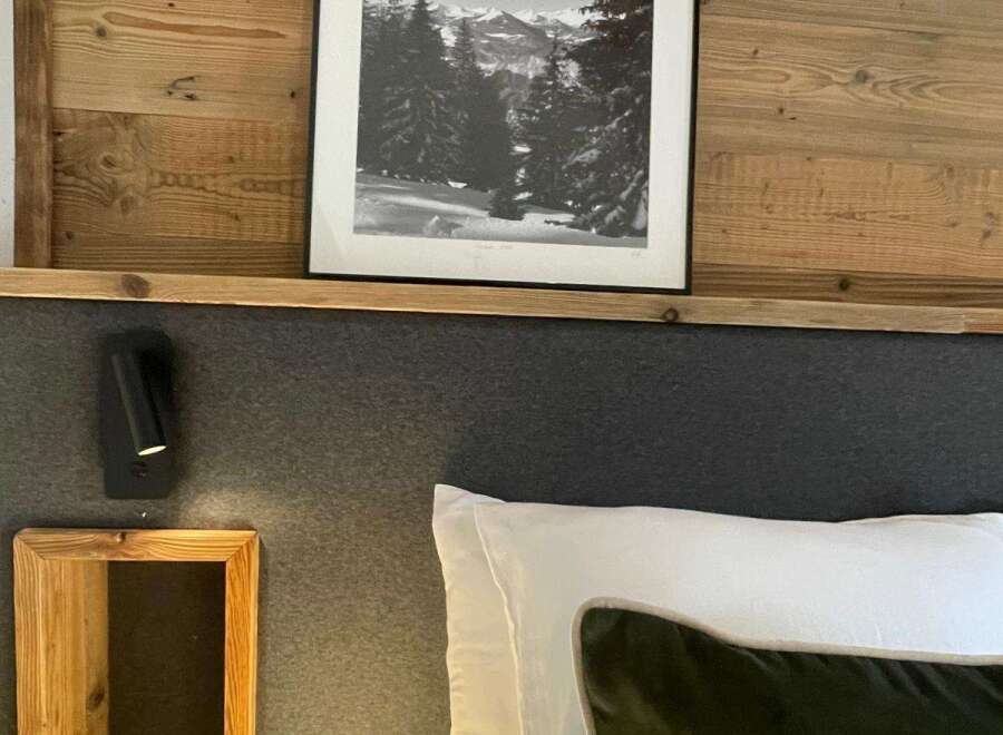 Cozy up in this charming bedroom featuring a stunning black and white mountain landscape print.