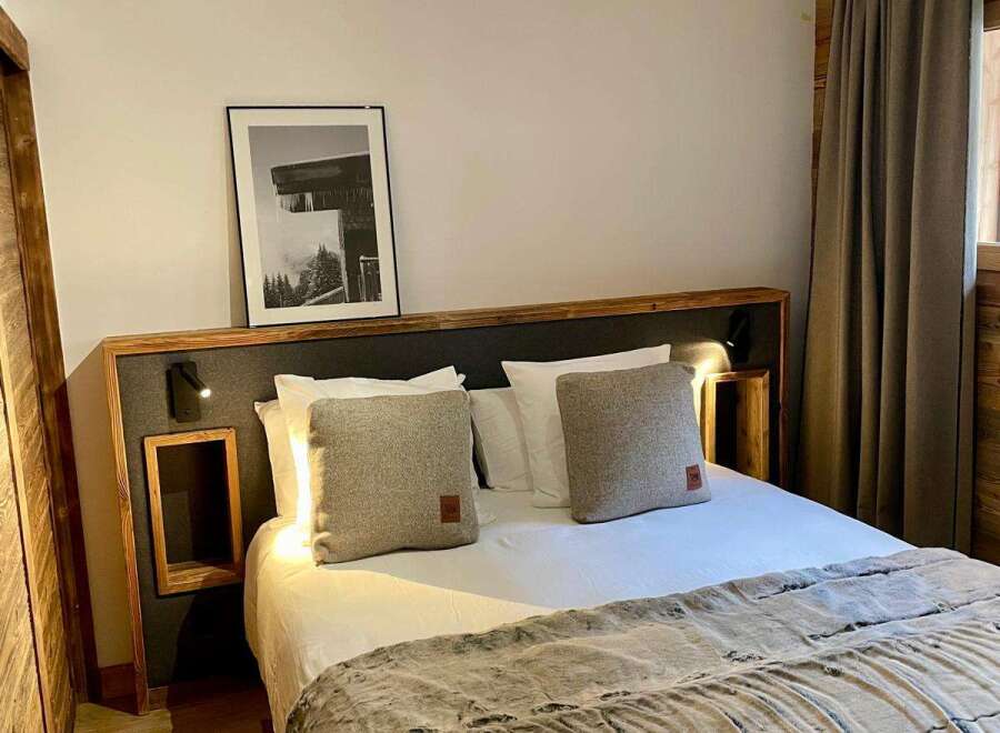 Cozy bedroom with a comfortable bed and stylish decor.