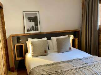 Cozy bedroom with a comfortable bed and stylish decor.