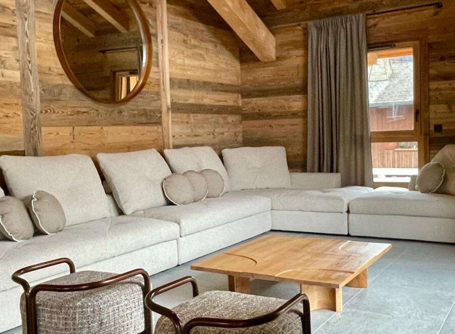 Experience rustic charm in this cozy living space, featuring stunning wooden walls and ceilings.