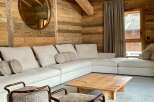 Experience rustic charm in this cozy living space, featuring stunning wooden walls and ceilings.