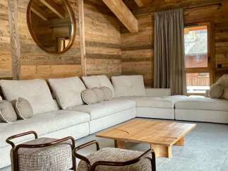 Experience rustic charm in this cozy living space, featuring stunning wooden walls and ceilings.