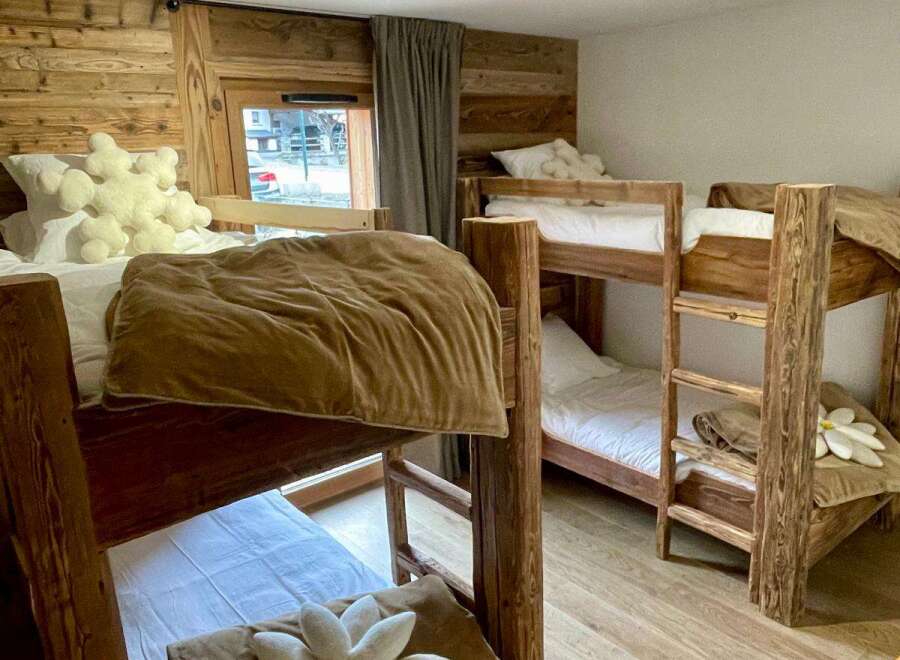 Cozy up in this charming bedroom featuring rustic wooden bunk beds, perfect for a family getaway.