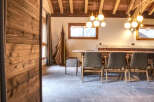 Experience the warmth of this inviting dining area, featuring a stunning wooden ceiling and elegant globe pendant lights.
