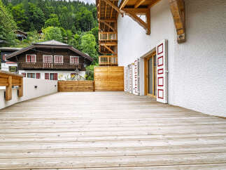 Experience the charm of alpine living with this stunning property featuring a spacious wooden deck perfect for outdoor entertaining.