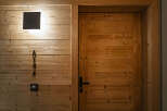 Experience rustic charm with this beautifully crafted wooden door, featuring a modern black handle and a subtle room number 'A104'.