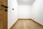 Experience modern living in this newly constructed space featuring sleek black fixtures and a warm, natural wood floor.