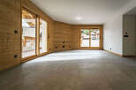 Experience modern alpine living in this stunning property featuring warm wood paneling and expansive sliding glass doors that open to breathtaking mountain views.