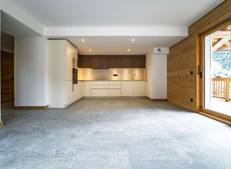 Experience modern living in this spacious open-plan apartment, featuring a sleek, contemporary kitchen with ample cabinet space and integrated appliances.