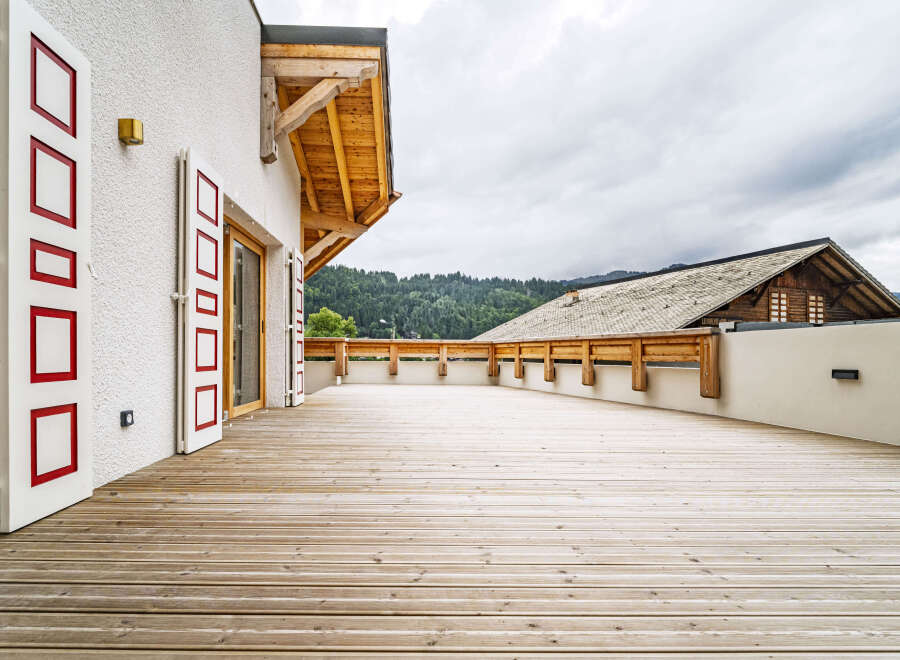 Experience breathtaking mountain views from this expansive wooden deck, perfect for outdoor entertaining or quiet relaxation.