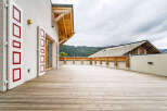 Experience breathtaking mountain views from this expansive wooden deck, perfect for outdoor entertaining or quiet relaxation.