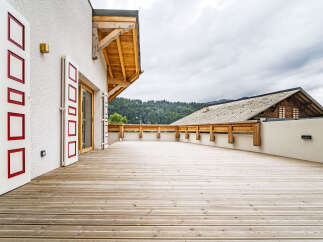 Experience breathtaking mountain views from this expansive wooden deck, perfect for outdoor entertaining or quiet relaxation.