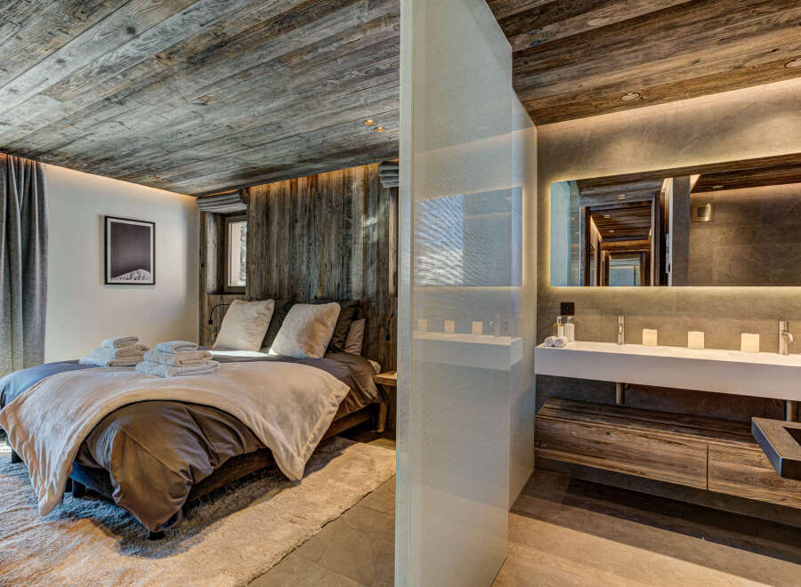 Experience rustic luxury in this stunning bedroom and bathroom.