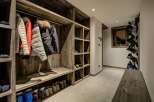 Step into a stylish ski chalet entryway, designed with rustic wooden features.