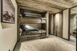 This cozy bedroom features a rustic bunk bed with a wooden frame, perfect for a mountain getaway.